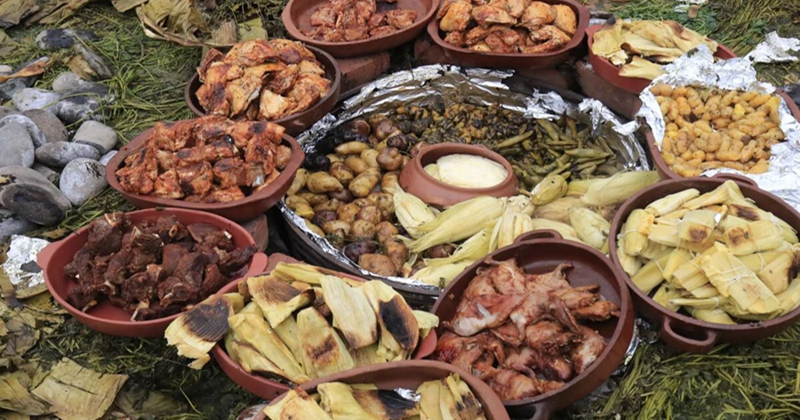 Preparing the traditional Pachamanca earth oven with hot volcanic stones
