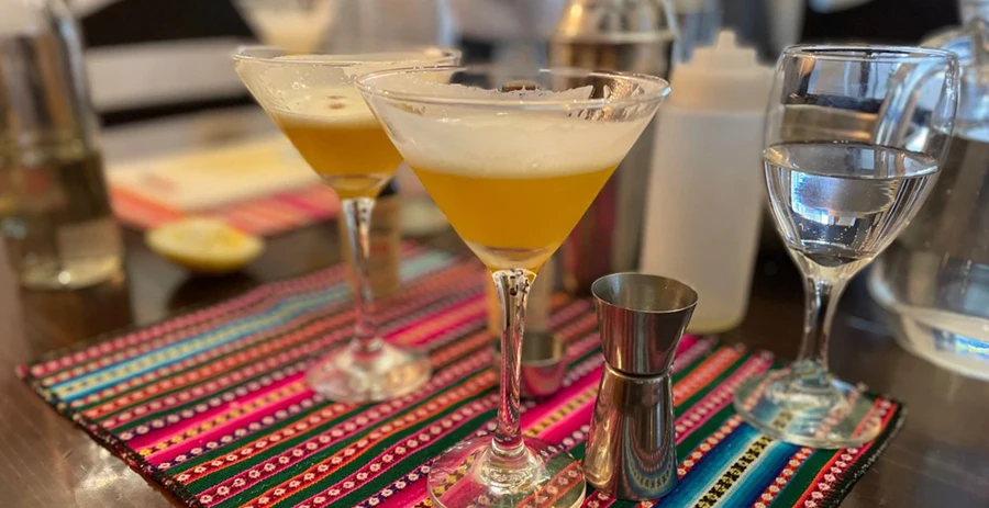 Making a traditional Peruvian Passion Fruit Sour cocktail
